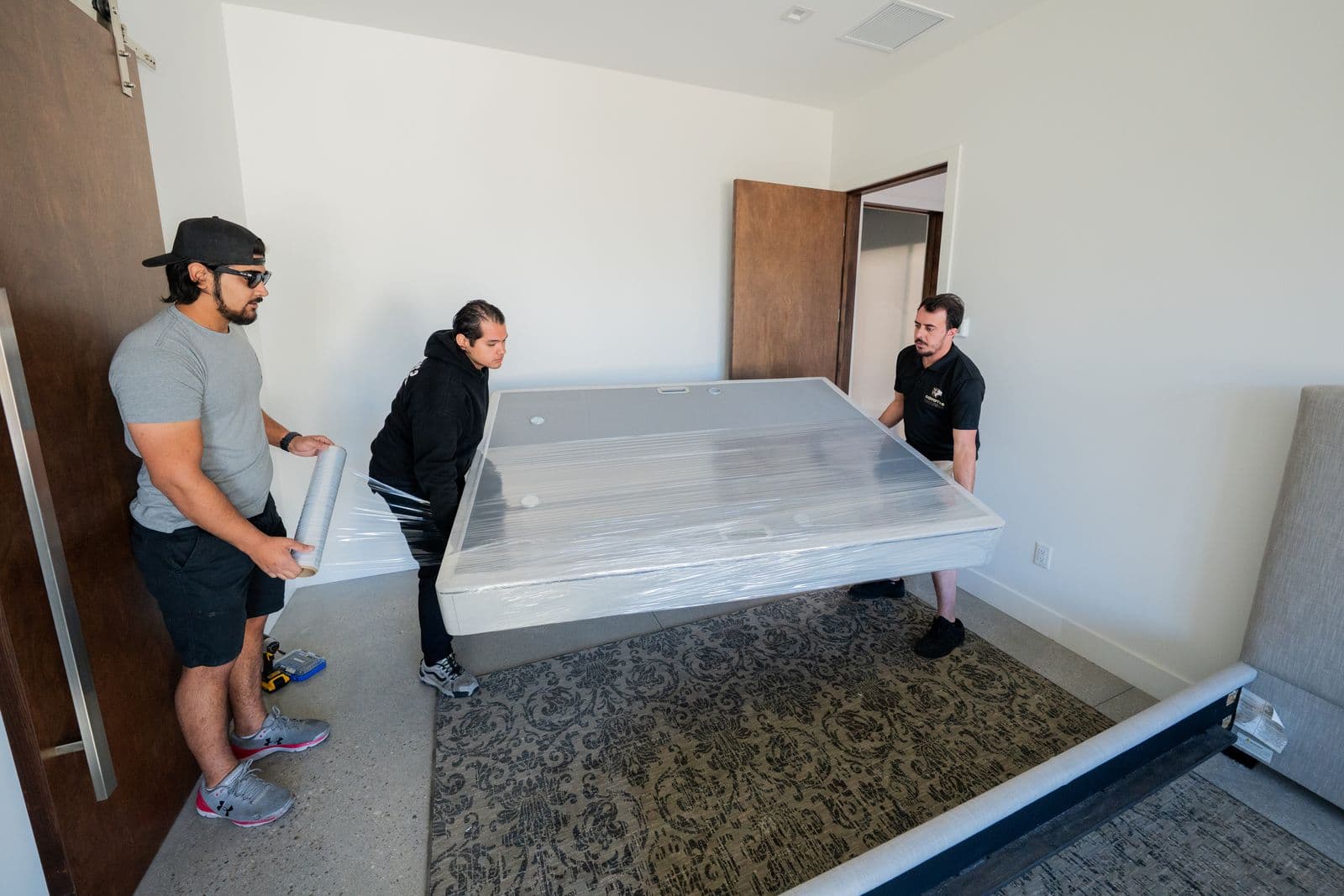 Two Coyotes Movers crew members carefully positioning furniture inside a Las Vegas home