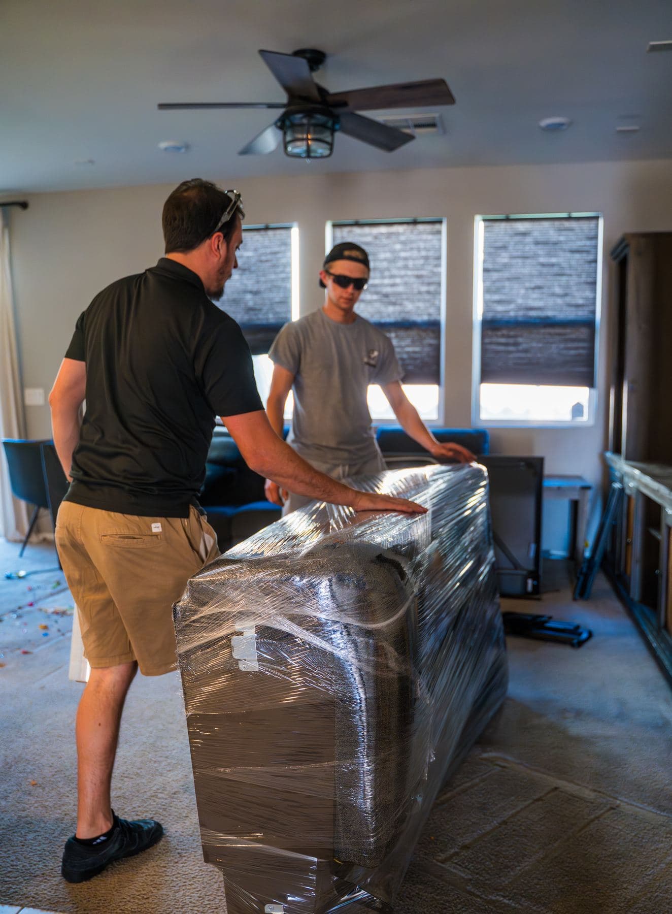 Coyotes Moving crew members carrying furniture during a move in Enterprise, Nevada