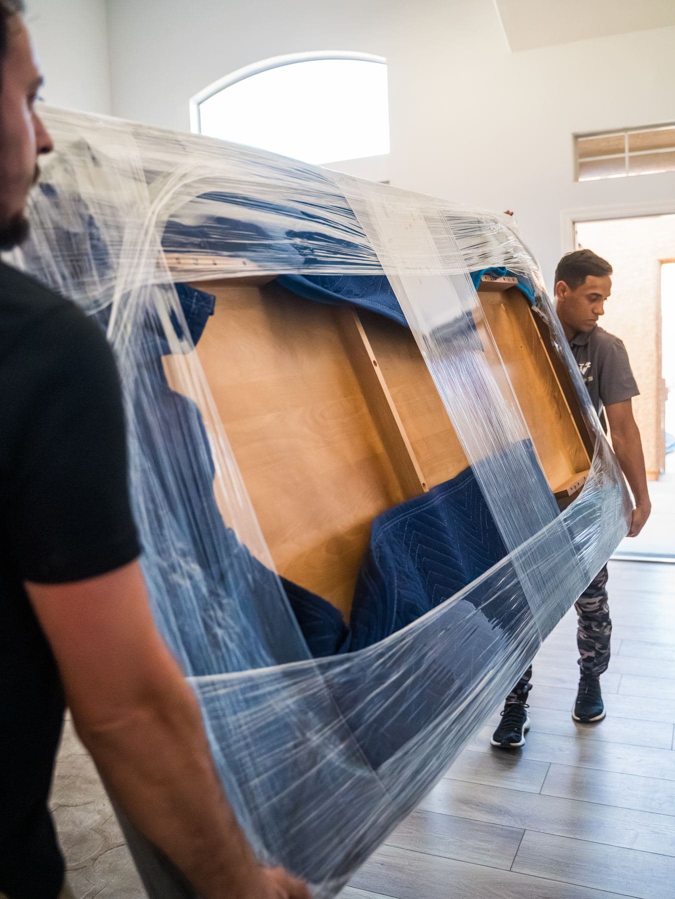 Coyotes Moving crew members carrying furniture during a move in Spring Valley, Nevada