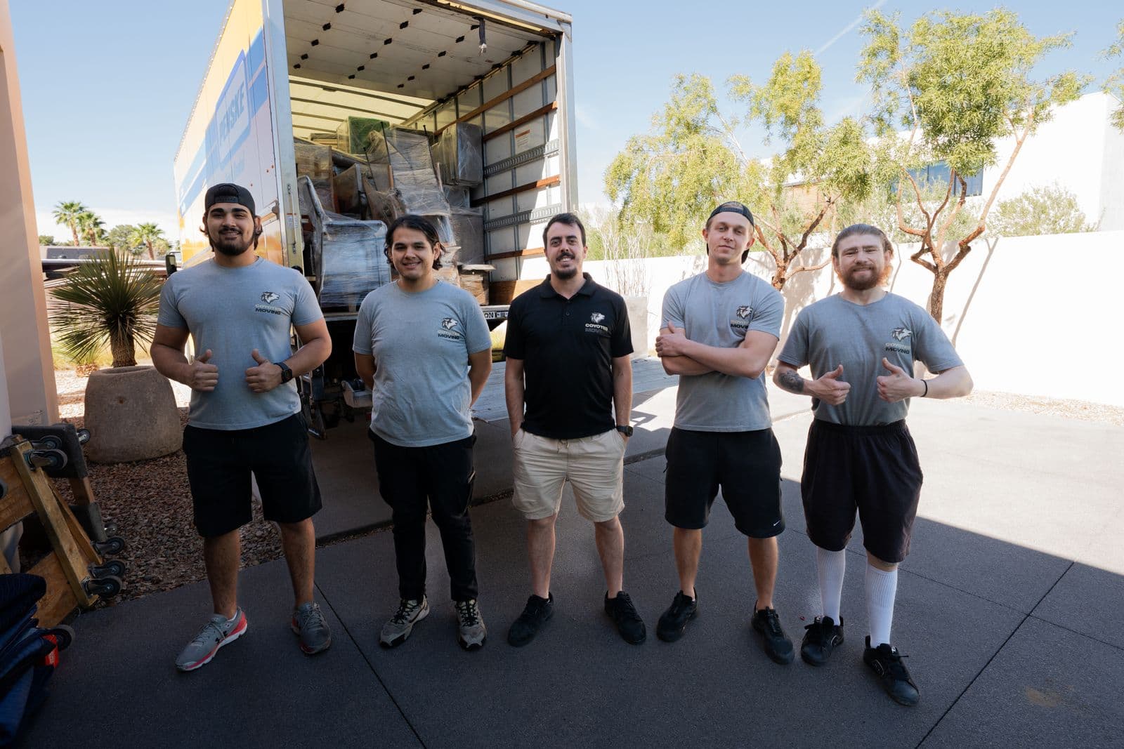 Coyotes Moving crew in front of a rental truck ready to load a Las Vegas move