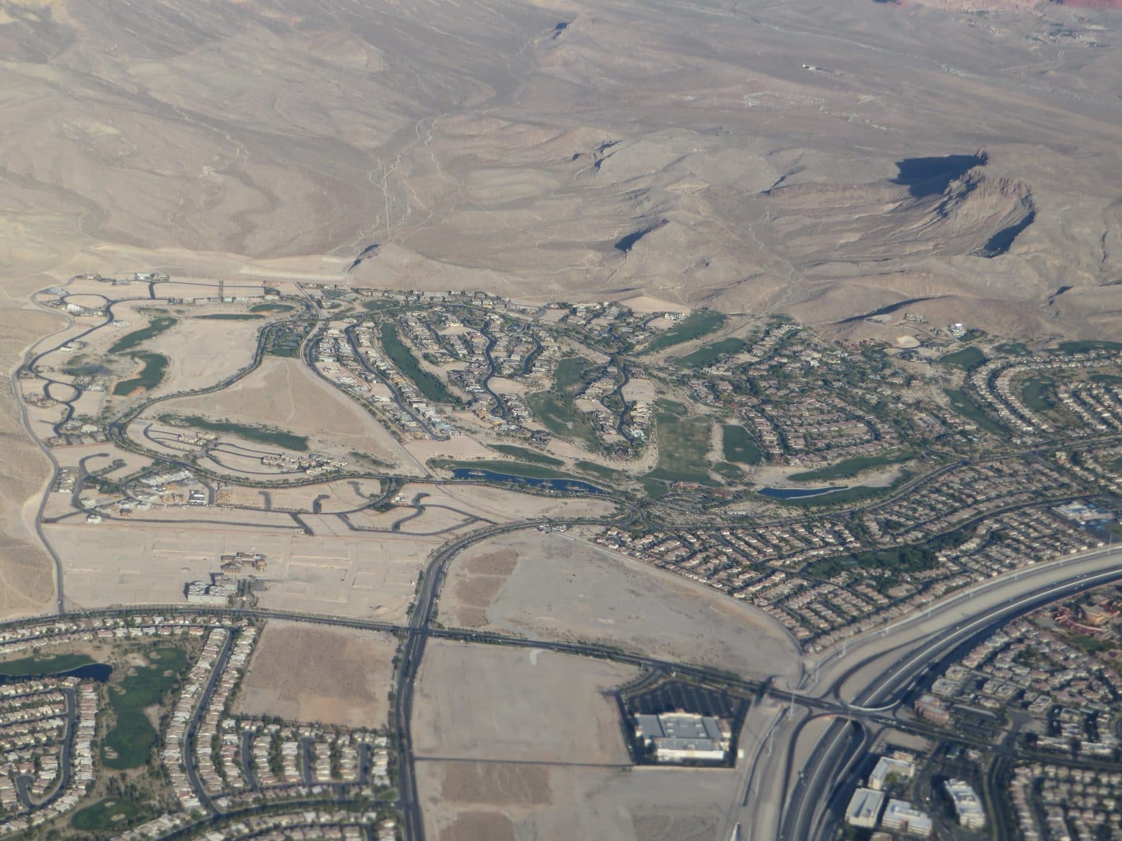 Aerial view of a Summerlin master-planned residential community with homes and a golf course